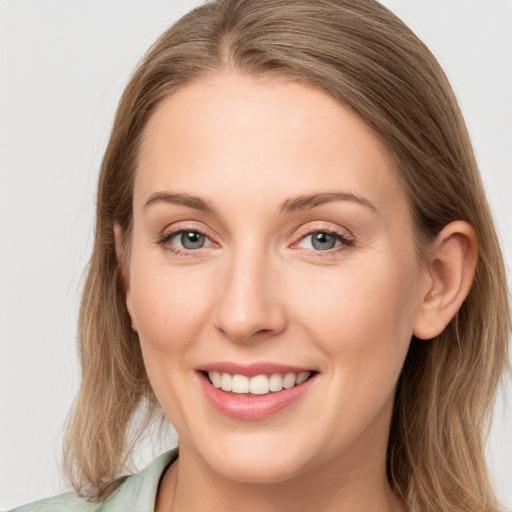 Joyful white young-adult female with long  brown hair and blue eyes