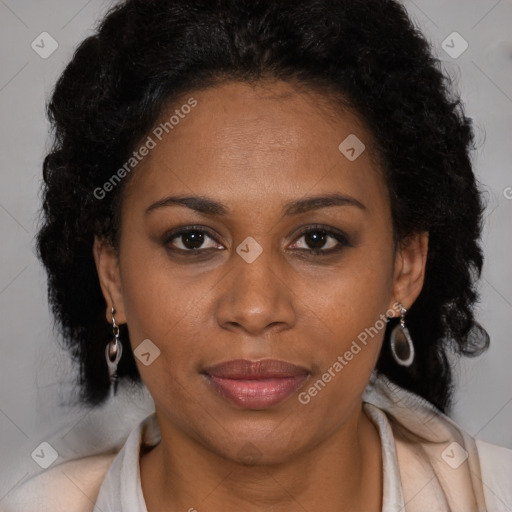 Joyful black adult female with long  brown hair and brown eyes