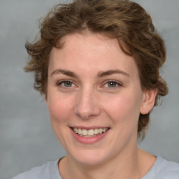 Joyful white young-adult female with medium  brown hair and blue eyes