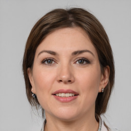 Joyful white young-adult female with medium  brown hair and grey eyes