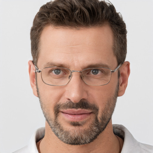 Joyful white adult male with short  brown hair and brown eyes