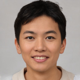 Joyful asian young-adult male with short  brown hair and brown eyes