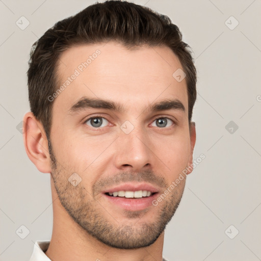 Joyful white young-adult male with short  brown hair and grey eyes