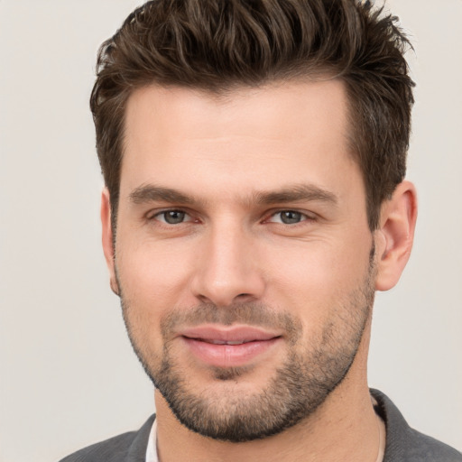 Joyful white young-adult male with short  brown hair and brown eyes