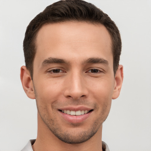 Joyful white young-adult male with short  brown hair and brown eyes