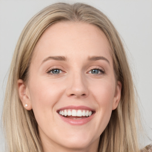 Joyful white young-adult female with long  brown hair and blue eyes