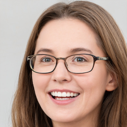 Joyful white young-adult female with long  brown hair and green eyes