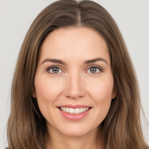 Joyful white young-adult female with long  brown hair and brown eyes