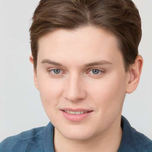 Joyful white young-adult female with short  brown hair and blue eyes