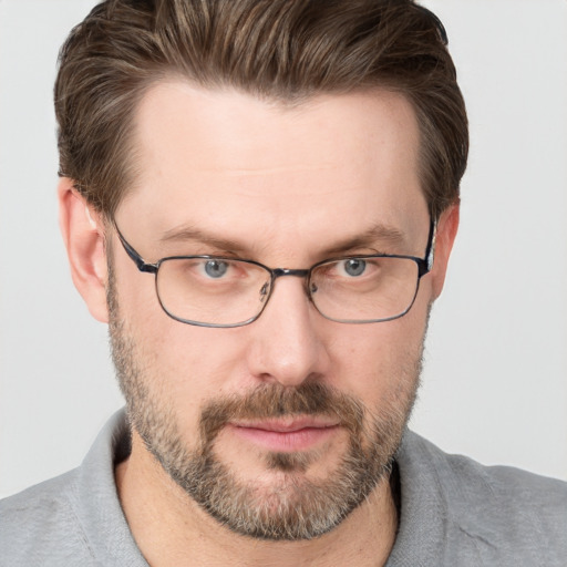 Joyful white adult male with short  brown hair and grey eyes