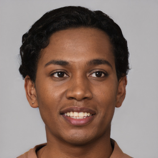 Joyful black young-adult male with short  black hair and brown eyes