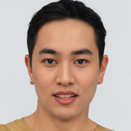 Joyful asian young-adult male with short  black hair and brown eyes