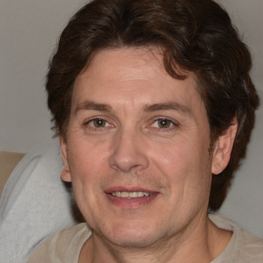 Joyful white adult male with medium  brown hair and brown eyes