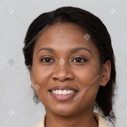 Joyful black adult female with medium  brown hair and brown eyes