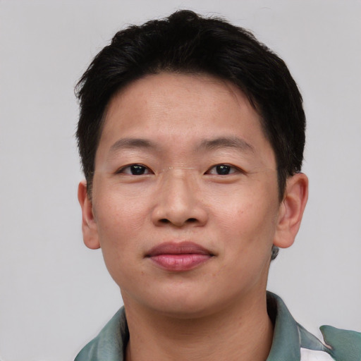 Joyful asian young-adult male with short  black hair and brown eyes