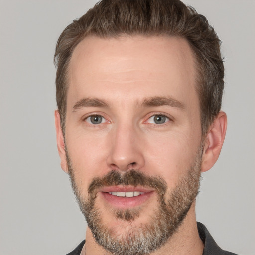 Joyful white adult male with short  brown hair and brown eyes