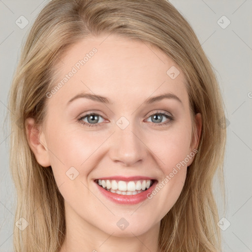 Joyful white young-adult female with long  brown hair and blue eyes