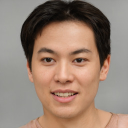 Joyful asian young-adult male with short  brown hair and brown eyes