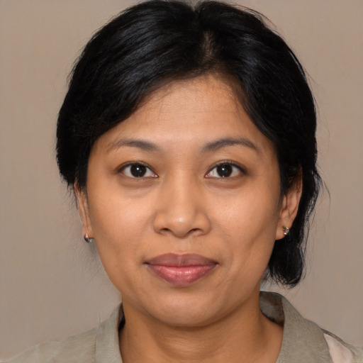 Joyful asian adult female with medium  brown hair and brown eyes
