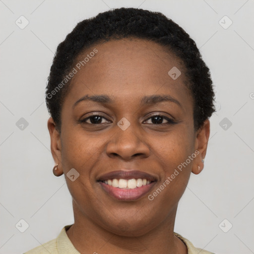 Joyful black young-adult female with short  black hair and brown eyes