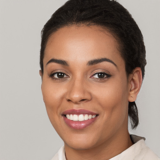 Joyful latino young-adult female with short  brown hair and brown eyes