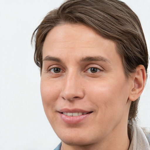 Joyful white young-adult female with medium  brown hair and grey eyes