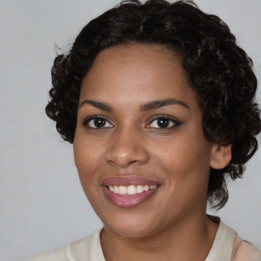 Joyful black young-adult female with medium  black hair and brown eyes