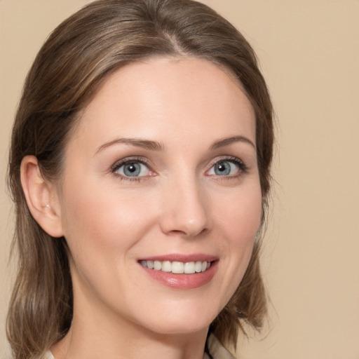 Joyful white young-adult female with medium  brown hair and blue eyes