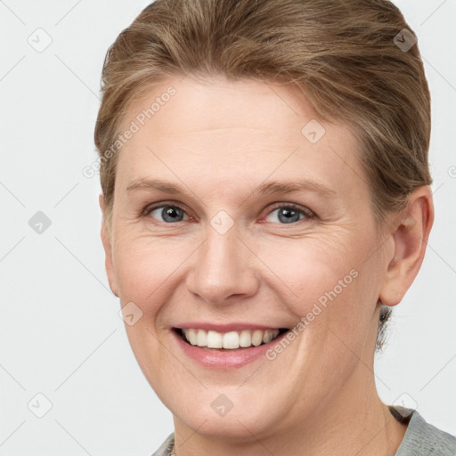 Joyful white young-adult female with short  brown hair and grey eyes