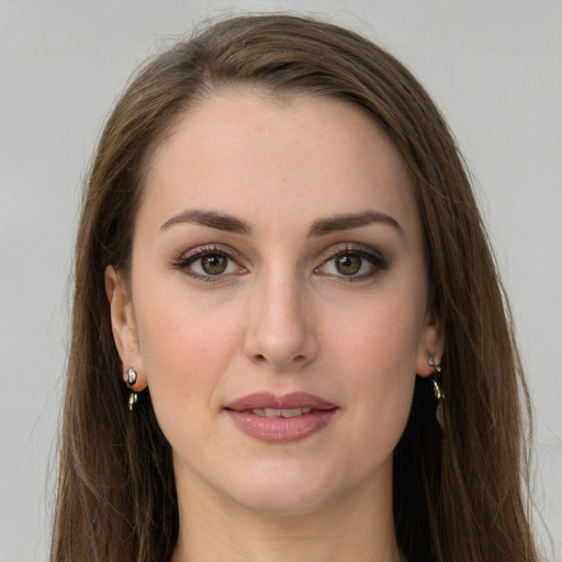 Joyful white young-adult female with long  brown hair and green eyes