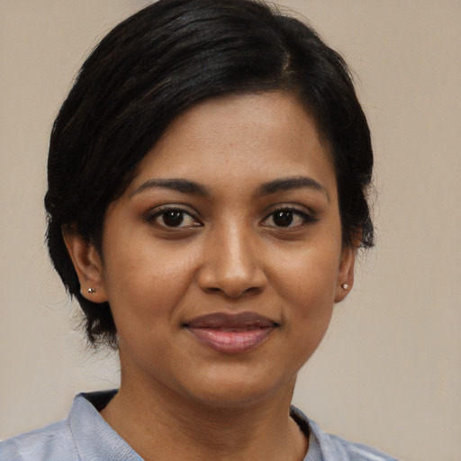 Joyful black young-adult female with medium  black hair and brown eyes
