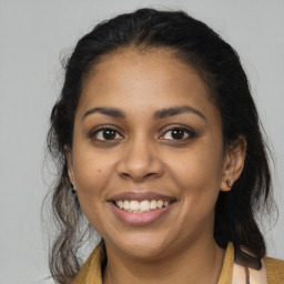 Joyful latino young-adult female with long  brown hair and brown eyes