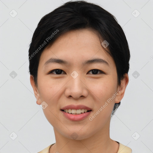 Joyful asian young-adult female with short  black hair and brown eyes