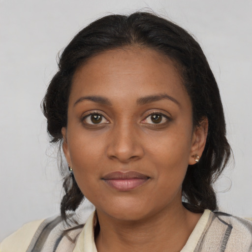 Joyful black young-adult female with medium  brown hair and brown eyes
