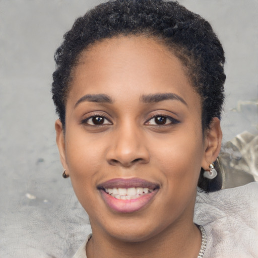 Joyful black young-adult female with short  brown hair and brown eyes