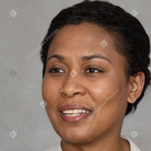 Joyful black young-adult female with short  brown hair and brown eyes