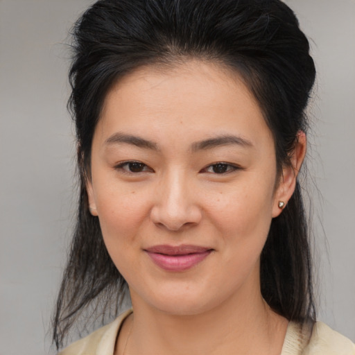 Joyful asian young-adult female with medium  brown hair and brown eyes