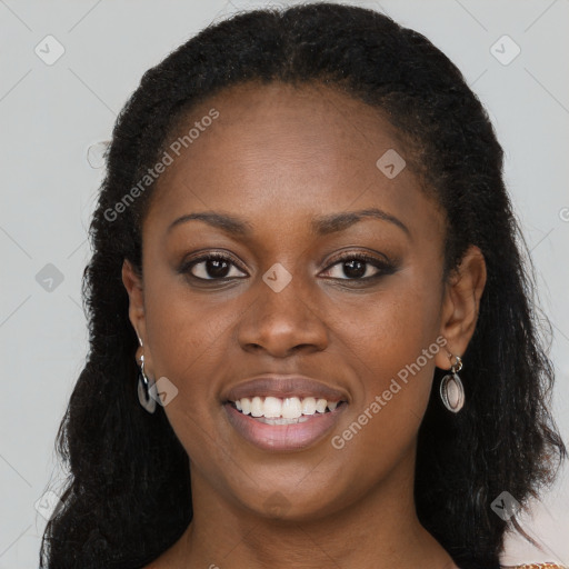 Joyful black young-adult female with long  brown hair and brown eyes