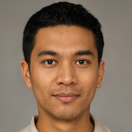 Joyful latino young-adult male with short  black hair and brown eyes