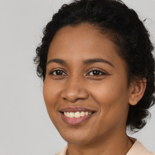 Joyful black young-adult female with medium  brown hair and brown eyes