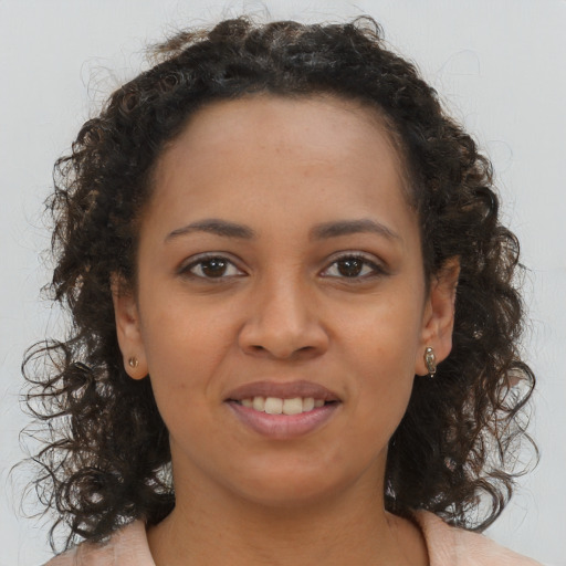 Joyful latino young-adult female with medium  brown hair and brown eyes