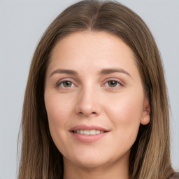 Joyful white young-adult female with long  brown hair and grey eyes