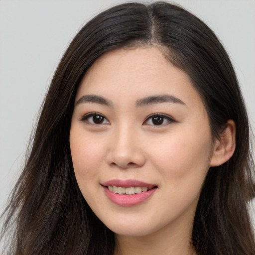 Joyful asian young-adult female with long  brown hair and brown eyes