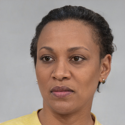 Joyful black adult female with short  brown hair and brown eyes