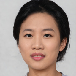 Joyful asian young-adult female with medium  black hair and brown eyes