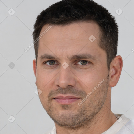 Joyful white adult male with short  brown hair and brown eyes