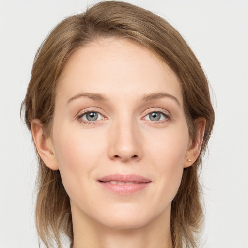 Joyful white young-adult female with long  brown hair and blue eyes