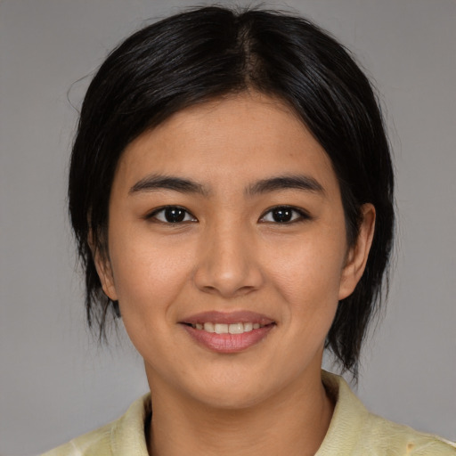 Joyful latino young-adult female with medium  black hair and brown eyes