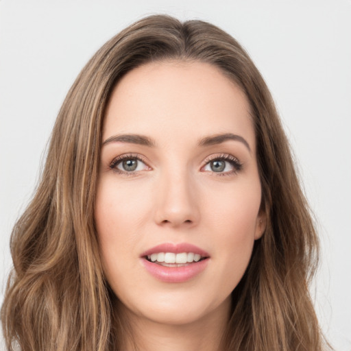 Joyful white young-adult female with long  brown hair and green eyes