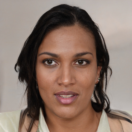 Joyful black young-adult female with medium  brown hair and brown eyes
